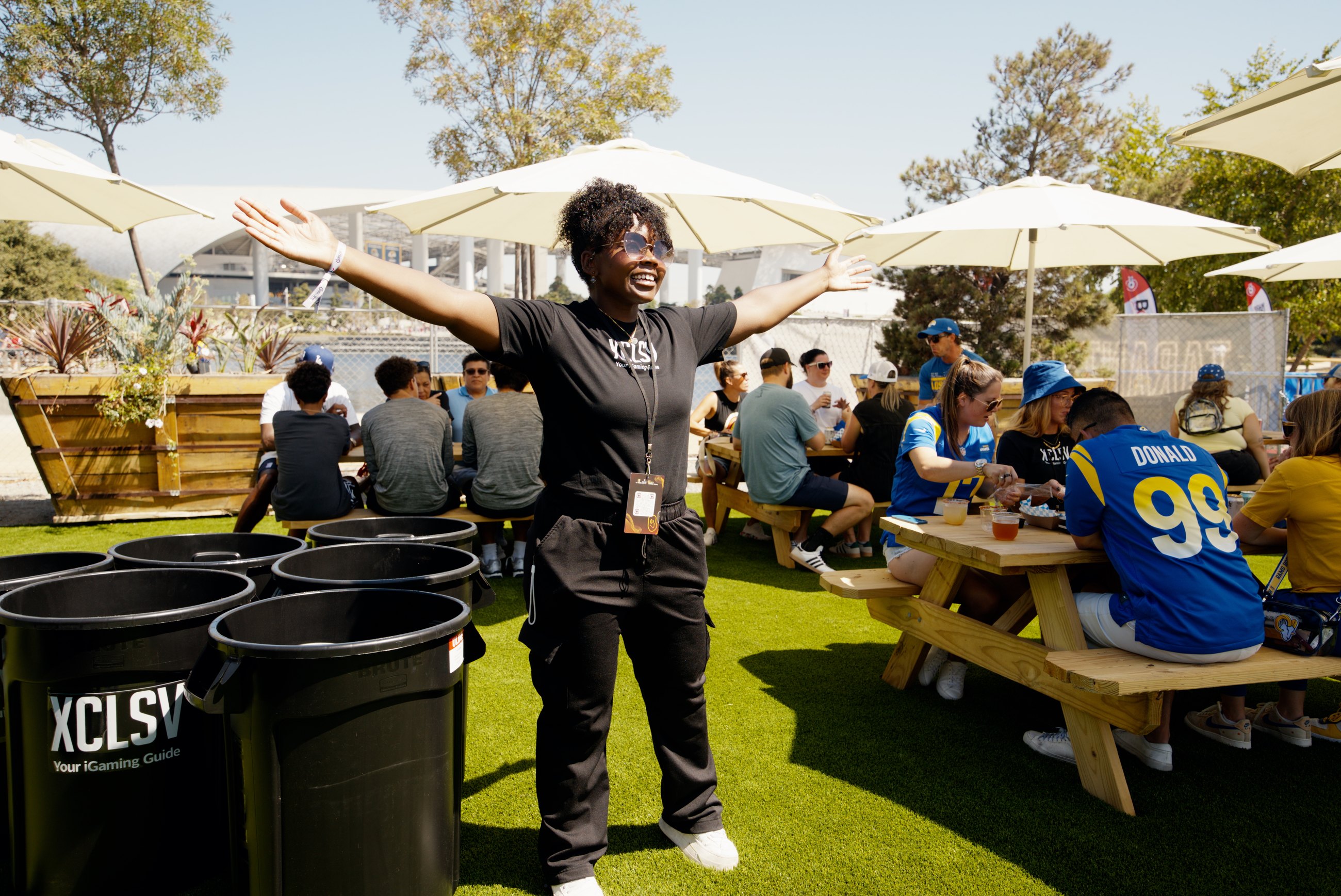 An event host welcoming guests inside a branded fan yard