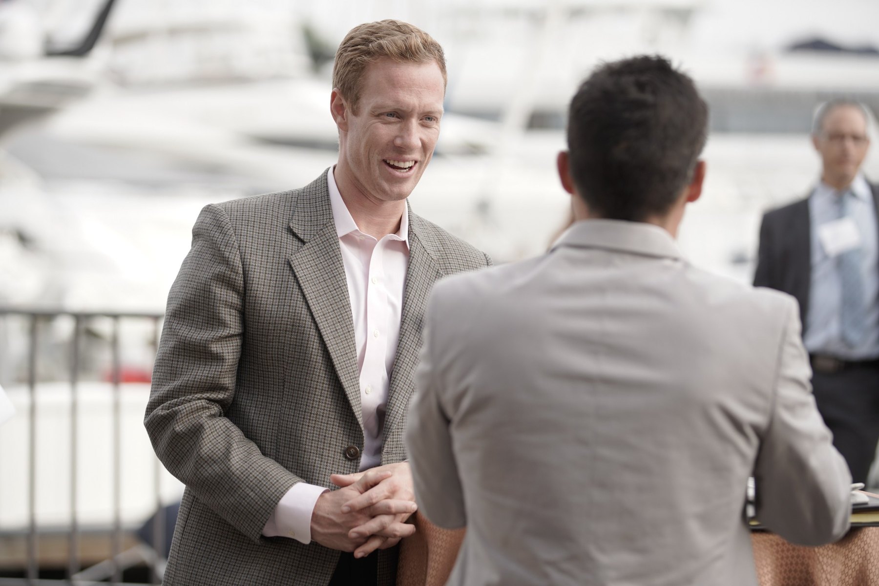 Professionals talking near a dock during an event