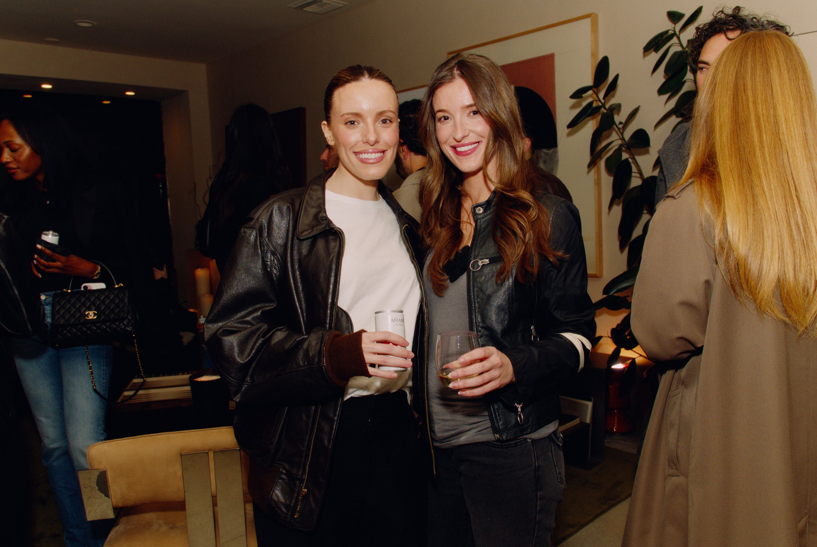 Two guests posing with drinks at House of Leon