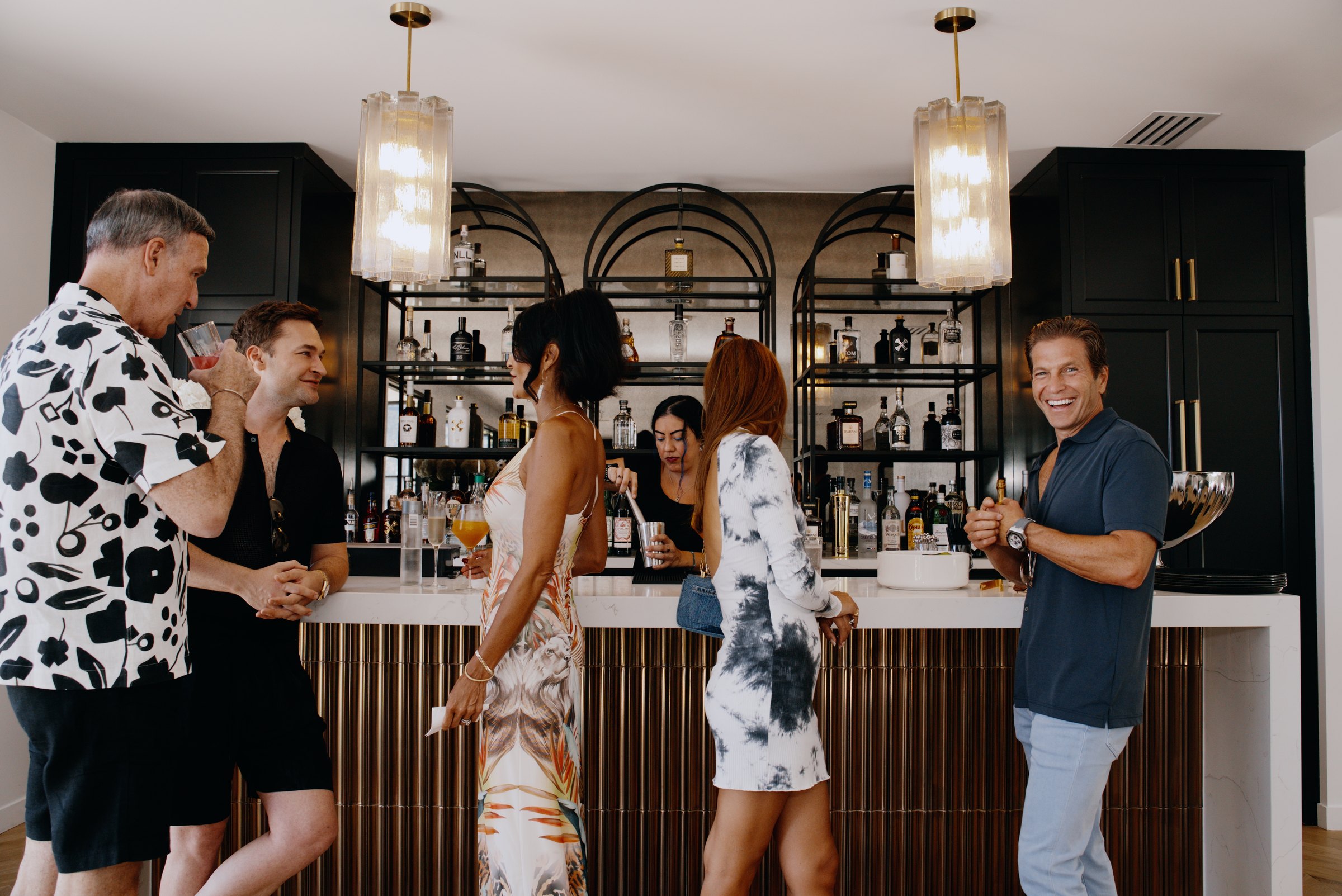 Guests gathered around a polished private bar
