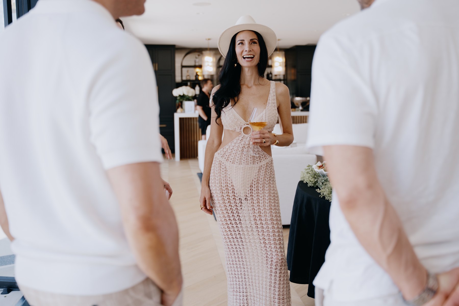 A guest framed between two people at a private event